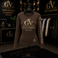 A brown long-sleeve crewneck sweatshirt with gold 'GV Ghetto Vengeance Wear' branding on the front and sleeve, displayed on a black hanger in a branded retail showroom.
