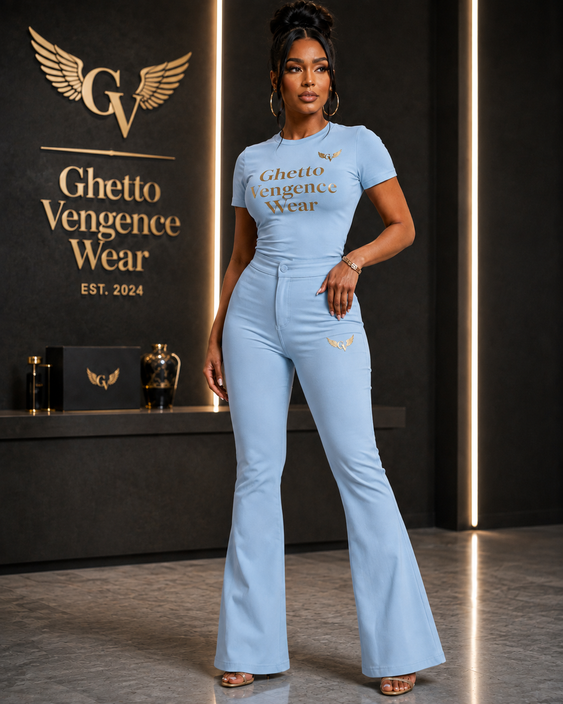 Elevated streetwear meets sophisticated style in the Ghetto Vengence Wear Signature Set. This coordinated women's look features a fitted short-sleeve top paired with high-waisted flare-leg pants for a sleek, flattering silhouette. Rich gold Ghetto Vengence Wear lettering across the chest and signature GV wing logo detailing give the set a polished luxury finish.

Fitted short-sleeve top with gold GV lettering
High-waisted flare-leg pants for a flattering silhouette
Signature GV wing logo detail
